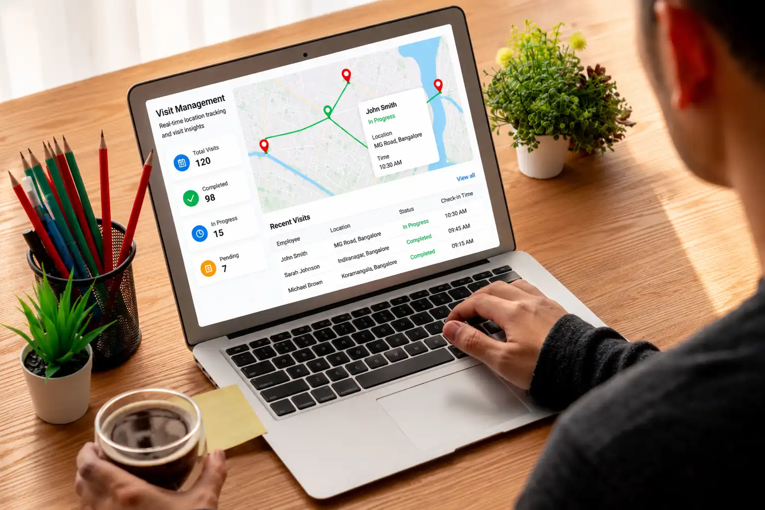 Time Champ visit management dashboard on a laptop — real-time location tracking and visit insights